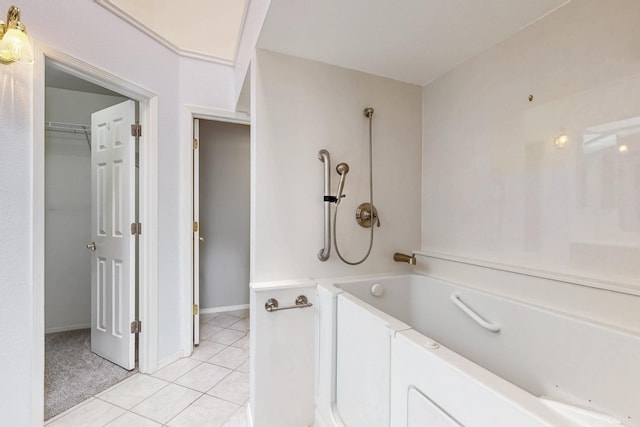 bathroom with baseboards, a bath, and tile patterned floors