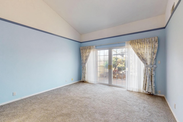 empty room with vaulted ceiling, french doors, carpet, and baseboards