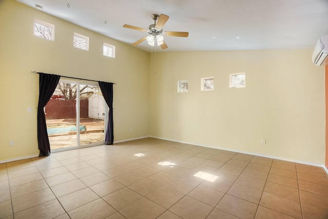 tiled empty room with a ceiling fan, high vaulted ceiling, and baseboards