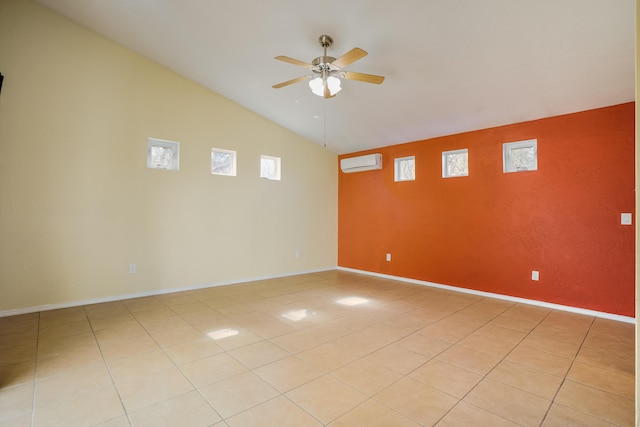 spare room with baseboards, a ceiling fan, a wall unit AC, vaulted ceiling, and light tile patterned flooring