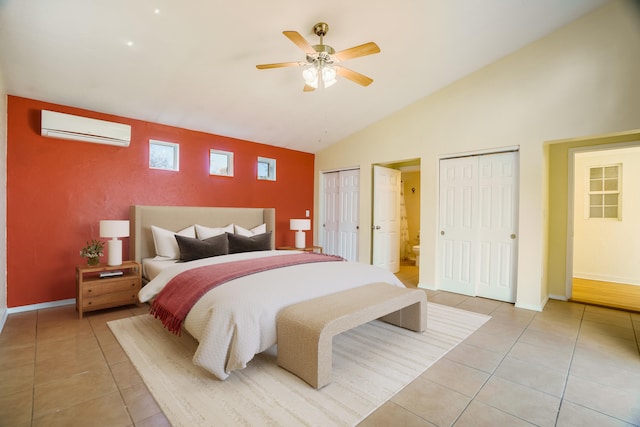 bedroom with multiple closets, an AC wall unit, light tile patterned flooring, and baseboards