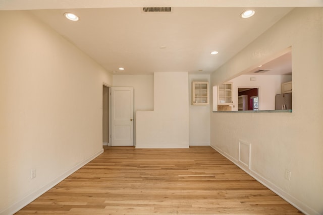 spare room featuring recessed lighting, baseboards, visible vents, and light wood finished floors