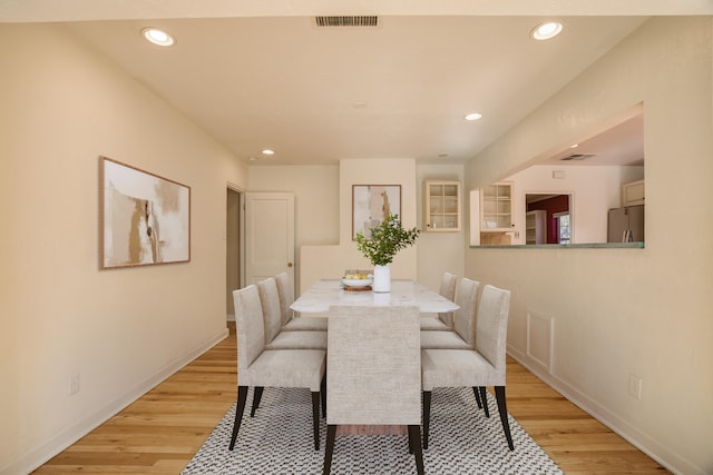 dining space with light wood-type flooring, baseboards, visible vents, and recessed lighting