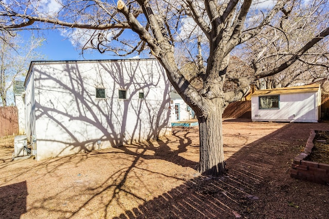 view of yard featuring an outdoor structure and fence