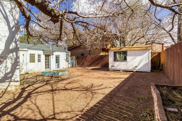 view of yard featuring an outbuilding, a storage unit, and a fenced backyard