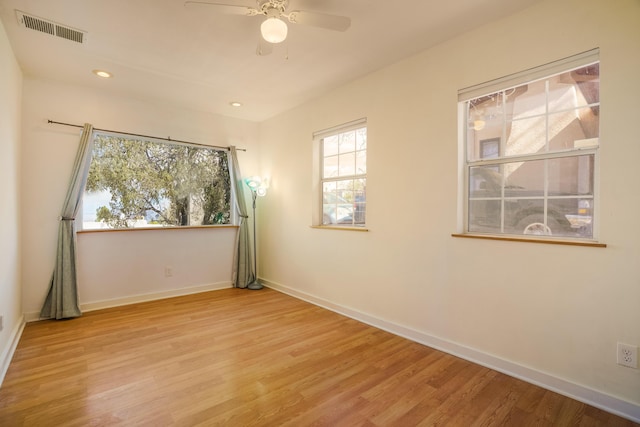 spare room featuring recessed lighting, a ceiling fan, visible vents, baseboards, and light wood finished floors