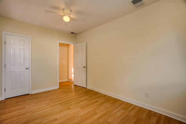 unfurnished bedroom with light wood-style flooring, visible vents, ceiling fan, and baseboards