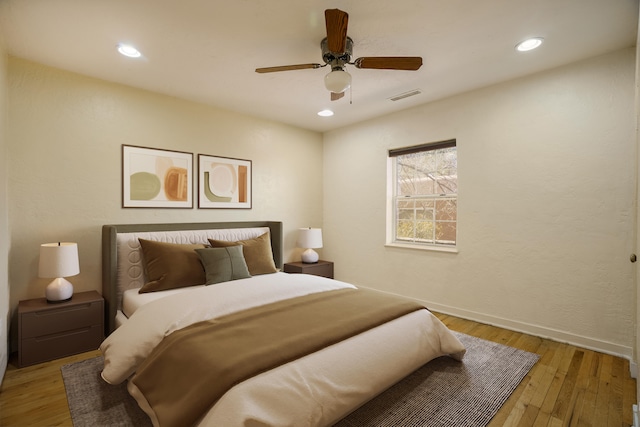 bedroom with baseboards, visible vents, ceiling fan, light wood-style floors, and recessed lighting