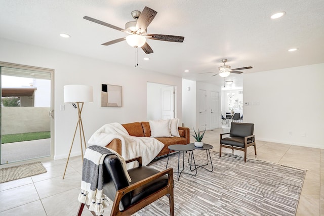 living room featuring light tile patterned floors, ceiling fan, a textured ceiling, and recessed lighting