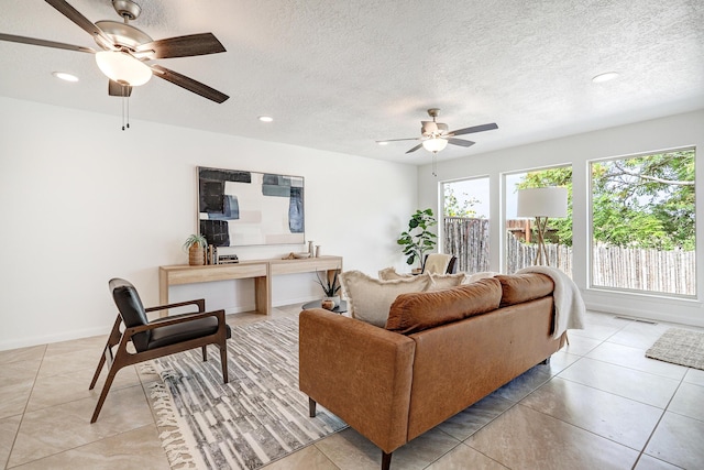 living area featuring a textured ceiling, ceiling fan, light tile patterned floors, recessed lighting, and visible vents