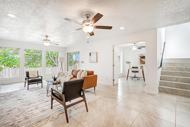 living room featuring a textured ceiling, light tile patterned flooring, recessed lighting, baseboards, and stairs