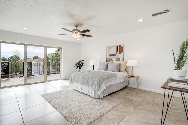 bedroom with a textured ceiling, recessed lighting, visible vents, baseboards, and access to exterior