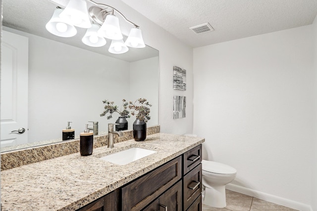 bathroom featuring visible vents, toilet, tile patterned flooring, a textured ceiling, and vanity