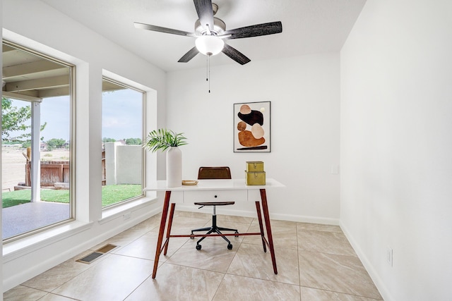 office featuring a ceiling fan, visible vents, baseboards, and light tile patterned floors