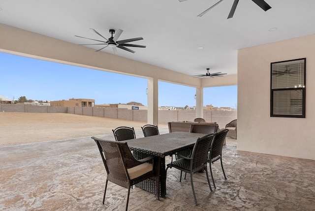 view of patio featuring ceiling fan, outdoor dining space, and a fenced backyard