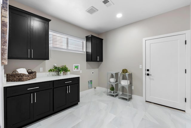 washroom with visible vents, washer hookup, cabinet space, and electric dryer hookup