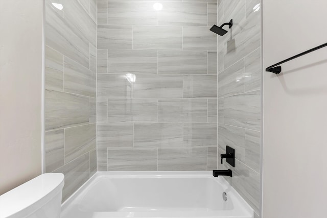 bathroom featuring shower / bathtub combination and toilet