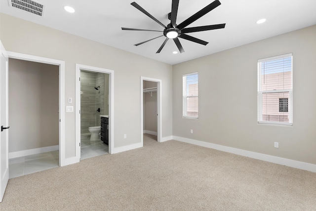 unfurnished bedroom featuring light carpet, multiple windows, visible vents, and recessed lighting