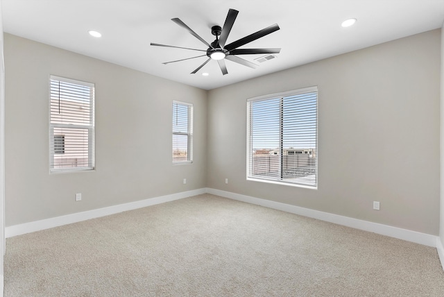 empty room with baseboards, light colored carpet, visible vents, and recessed lighting