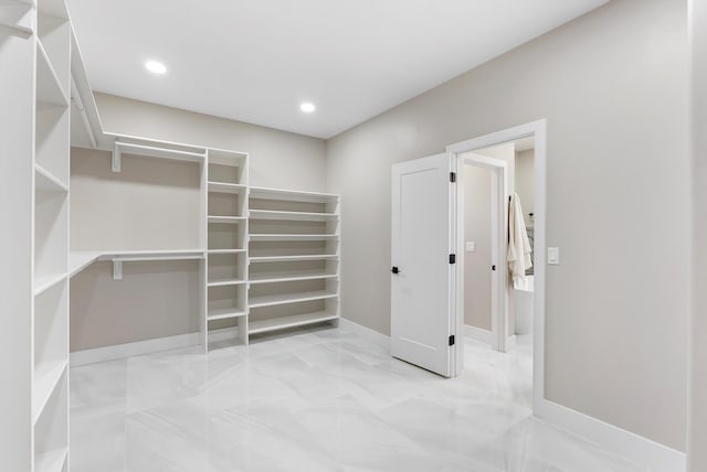 spacious closet featuring marble finish floor