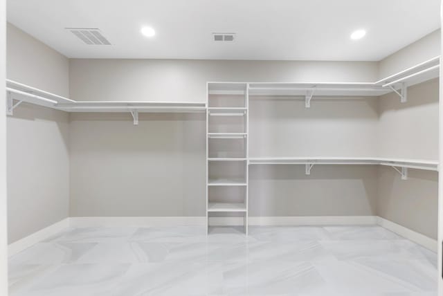 spacious closet featuring visible vents