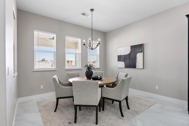 dining space featuring marble finish floor, visible vents, a notable chandelier, and baseboards