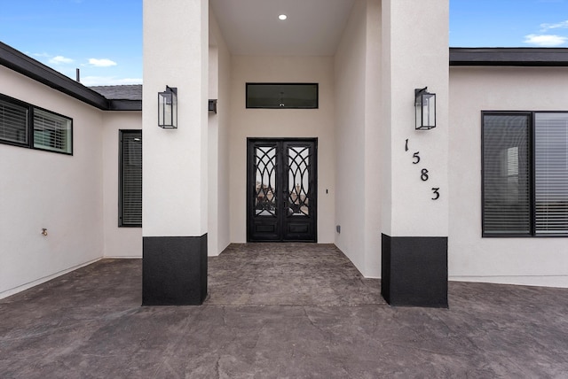 doorway to property featuring stucco siding