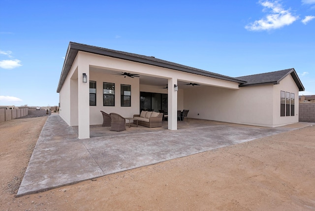 back of house with a patio, stucco siding, outdoor lounge area, a ceiling fan, and fence