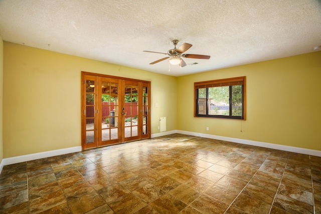 spare room with ceiling fan, french doors, and baseboards