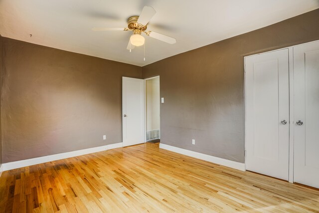 unfurnished bedroom with ceiling fan, light wood finished floors, visible vents, and baseboards