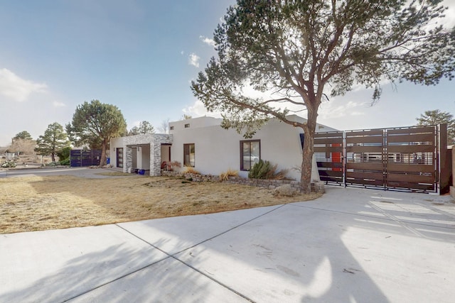 view of front of home featuring a gate and stucco siding