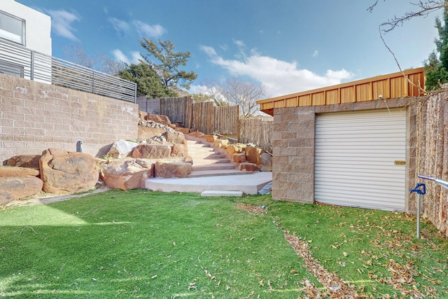 view of yard with a fenced backyard and an outdoor structure