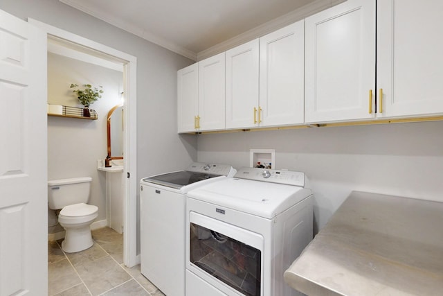 laundry room featuring ornamental molding, washing machine and dryer, cabinet space, and baseboards