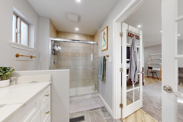 full bath featuring a stall shower, visible vents, vanity, and recessed lighting