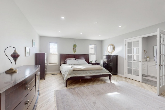 bedroom featuring baseboards, french doors, light wood-type flooring, and recessed lighting