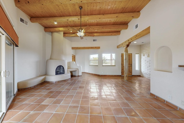 unfurnished living room with beam ceiling, light tile patterned flooring, and visible vents