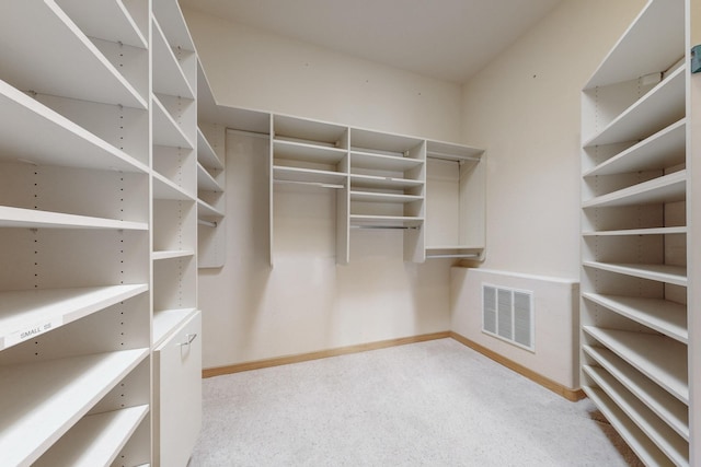 walk in closet featuring visible vents and light colored carpet