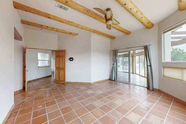 spare room with light tile patterned floors, a wealth of natural light, beamed ceiling, and visible vents