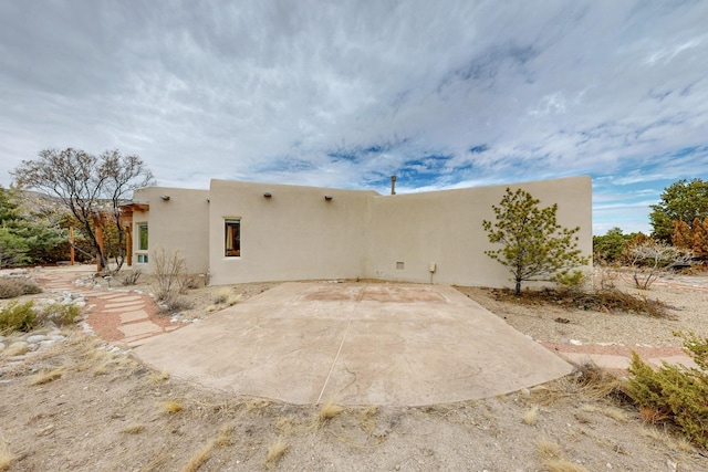 exterior space with a patio and stucco siding