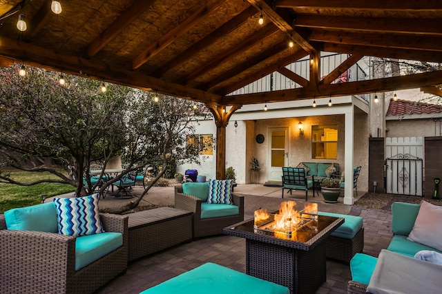 view of patio featuring a gazebo and an outdoor living space with a fire pit