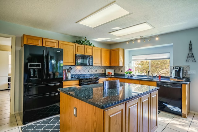 kitchen with light tile patterned floors, a kitchen island, a sink, decorative backsplash, and black appliances