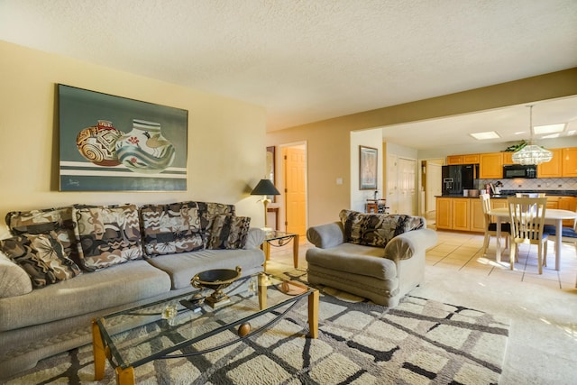 living area featuring light tile patterned floors, a textured ceiling, and light colored carpet