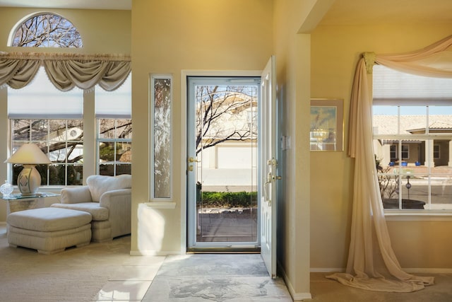 doorway to outside featuring plenty of natural light and baseboards