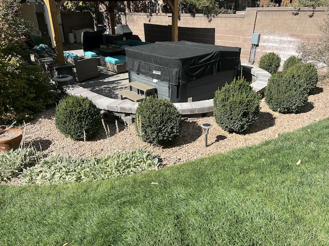 view of yard with a patio area, fence, a hot tub, and an outdoor hangout area