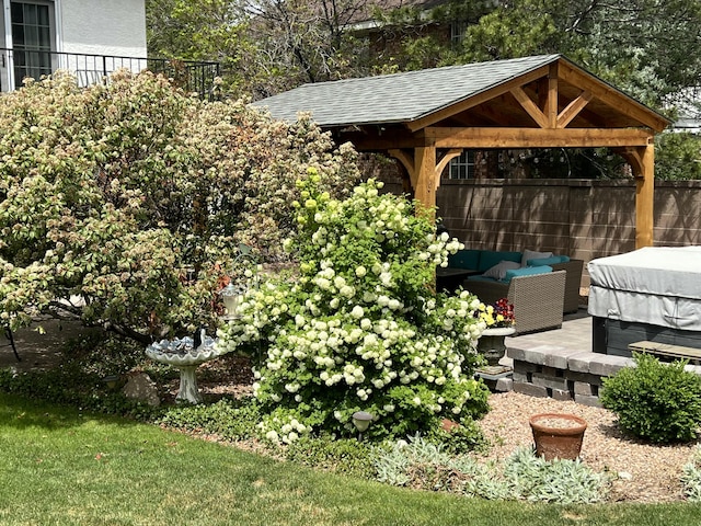 view of yard featuring fence, an outdoor living space, and a gazebo