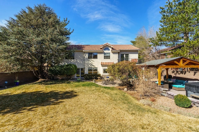 rear view of property with a patio, a tile roof, a yard, a gazebo, and outdoor lounge area