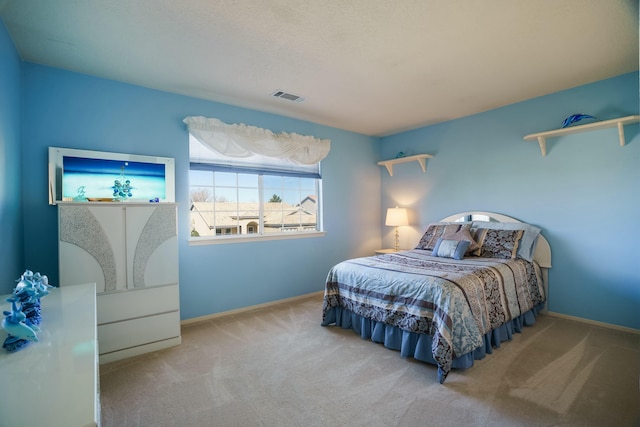 bedroom featuring baseboards, visible vents, and carpet flooring