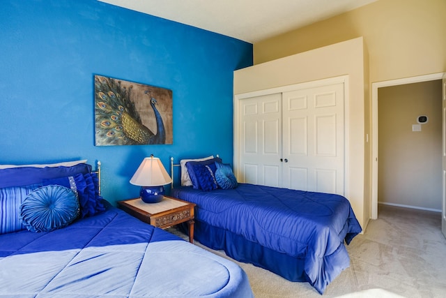 bedroom with carpet, baseboards, and a closet