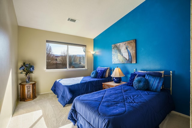 carpeted bedroom with lofted ceiling, baseboards, and visible vents