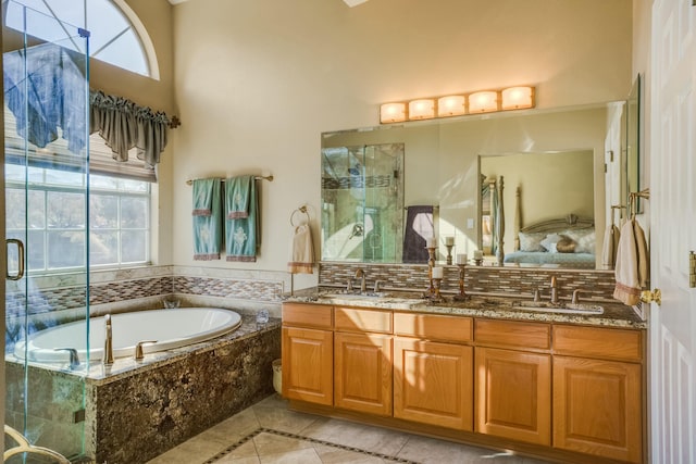 bathroom featuring a stall shower, plenty of natural light, and a sink